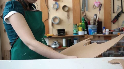 Woman in workshop cutting wood Stock Footage