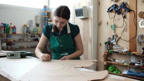 Woman in workshop cutting wood Stock Footage