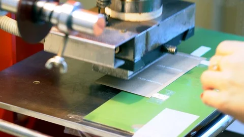 The woman in the workshop use press machine to get the embossed details Stock-Footage 120898720