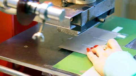 The woman in the workshop use press machine to get the embossed details Stock-Footage 120898958