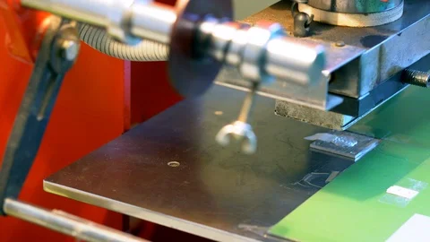 The woman in the workshop use press machine to get the embossed details Stock Footage 120899052
