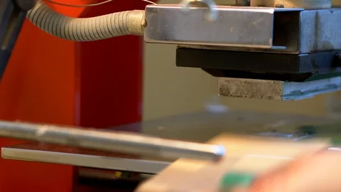 The woman in the workshop use press machine to get the embossed details Stock Footage 120899362