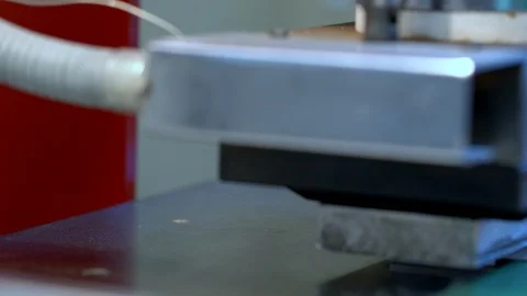 The woman in the workshop use press machine to get the embossed details Stock Footage 120899622