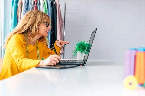 Woman in workshop working with computer Stock Photos
