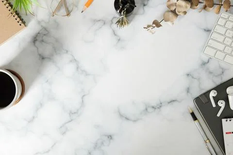Woman workspace with notebook, coffee cup and wireless ear phones on marble t Foto stock