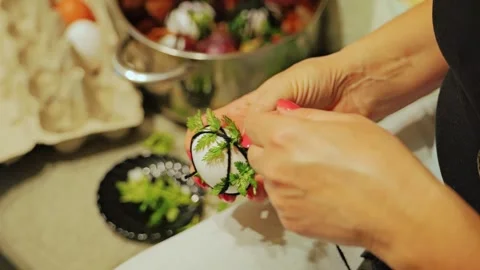 Woman Wraps Easter Egg With Fresh Herbs And Dark Thread In Detailed Slow Motion Stock Footage 344007791