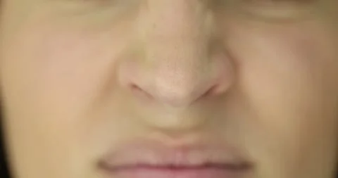 Woman wrinkles nose experiencing itching caused by allergies Stock Footage 280604974