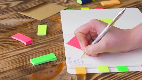 Woman write notes in notepad . Open notepad with office supplies. Stock Footage 77728037