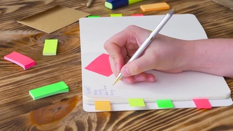 Woman write notes in notepad . Open notepad with office supplies. Stock Footage 77728102