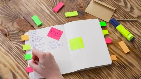 Woman write notes in notepad . Open notepad with office supplies. Stock Footage 77728179