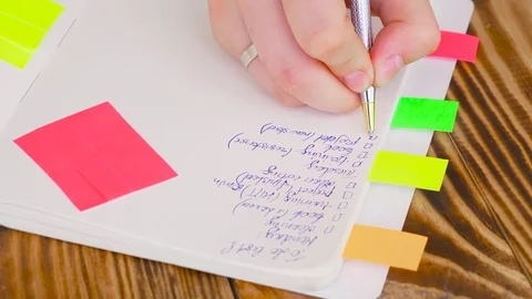 Woman write notes in notepad . Open notepad with office supplies. Video stock 77728190