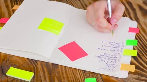 Woman write notes in notepad . Open notepad with office supplies. Stock Footage 77728192