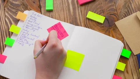Woman write notes in notepad . Open notepad with office supplies. Stock Footage 77728195