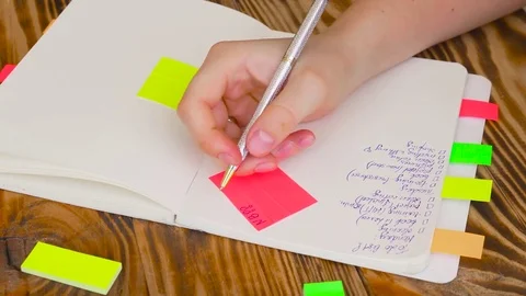 Woman write notes in notepad . Open notepad with office supplies. Stock Footage 77728216