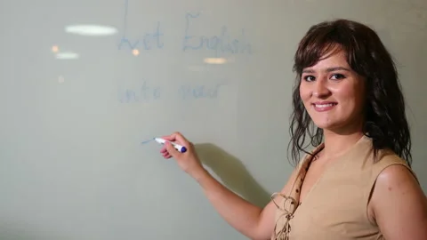 Woman write something with note white background. Young serious female english Stock Footage 137103486