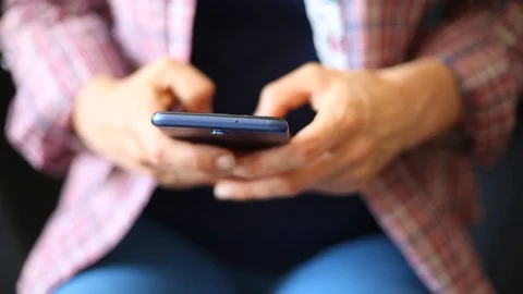 A woman writes a message in a social network on her smartphone. Close-up.  Video stock 111415696