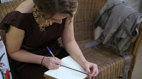 The woman writes in a notebook Stock Footage 55876356