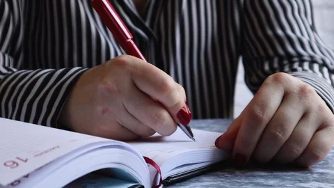 Woman writes something in a notebook. Stock Footage 127857868