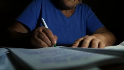 A woman writes something at the table Stock Footage 80351135