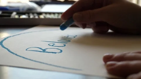 Woman Writing Beloved on a Piece of Paper with Blue Crayon, 4K Stock Footage