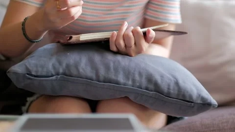 Woman writing a book while using tablet computer. Stock Footage 135347908