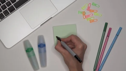Woman writing CALCULUS on notepad, close up. Laptop and stationery on the table Stock Footage 101889107