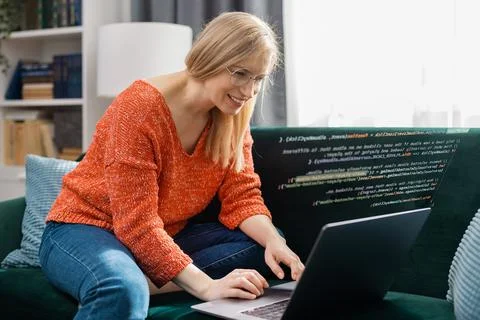 Woman writing code at home Stock Photos