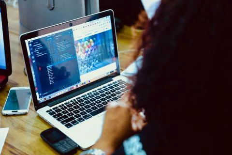 Woman writing code on Macbook Pro 写真素材