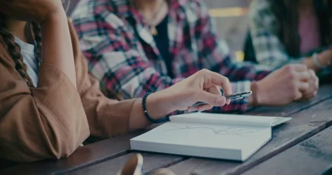 Woman Writing In Diary While Sitting Next To Friend Stock Footage 251896216