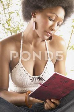 Woman writing in journal Stock Photos