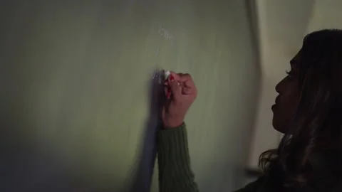 A Woman Writing a Math Problem on a Chalkboard Stock Footage 208795750