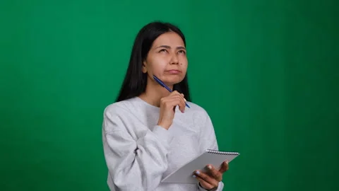 Woman writing a note on a notepad, planning and organizing her ideas. The paper Video stock 278082845