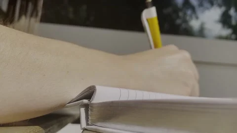A woman writing in a notebook, close-up Stock Footage 230614049