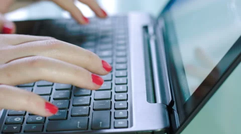Woman writing on a notebook computer: using mobile computer, web searching Stockbeeldmateriaal 42990411