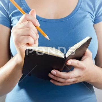 Woman writing in notebook Stock Photos