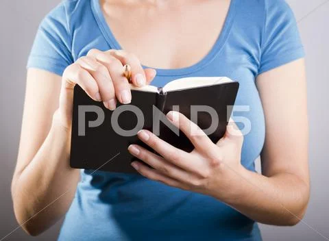 Woman writing in notebook Stock Photos