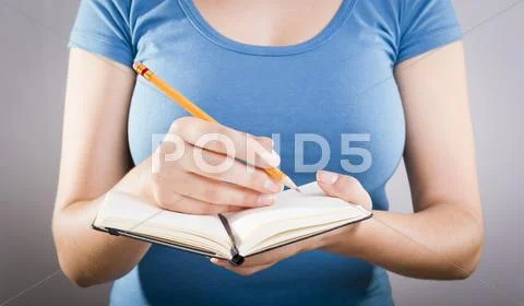 Woman writing in notebook Stock Photos