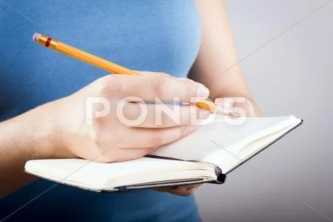 Woman writing in notebook Stock Photos