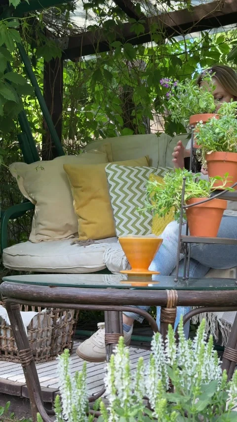 Woman Writing in Notebook While Relaxing in Cozy Garden Retreat Stock Footage 337192414