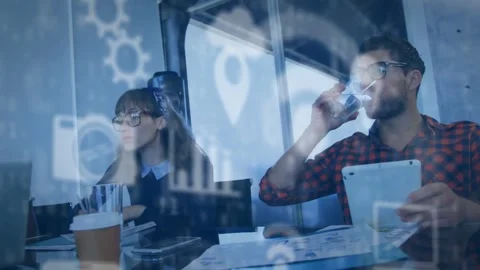 Woman writing notes after data overlays appearing, man reviewing tablet while Stock Footage 334312844