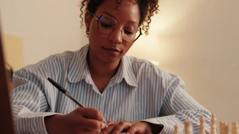 Woman Writing Notes With Chessboard Stock Footage 321639584