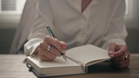 Woman Writing Notes in Journal during Psychology Session Stock Footage 340626189