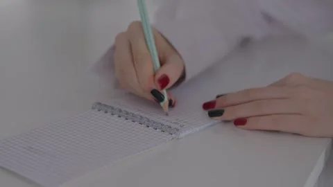 Woman Writing Notes in Notebook with Pencil, Close Up Study Scene Stock Footage 329889558