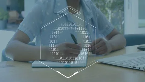 Woman writing notes while binary appearing on page and hexagon animating, typing Stock Footage 335235688