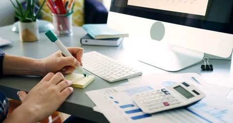 Woman Writing Post It Notes At Office Desk Stock Footage 100041127