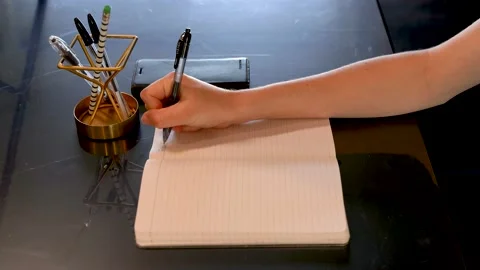 Woman writing task list on lined paper, side view. Stock Footage 157818280