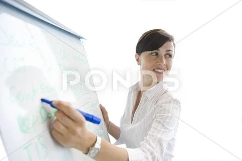 Woman writing on whiteboard, cut out Stock Photos