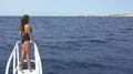 The woman in yacht pose on the background of the ocean. Wide angle 4k or 4k+ Resolution