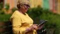 Woman in yellow jacket using electronic book. Woman holding e-book HD Footage
