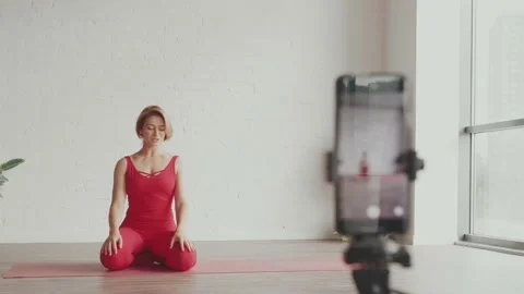 Woman yoga teacher record tutorial how to do downward position in yoga. Online 스톡 동영상 161670990